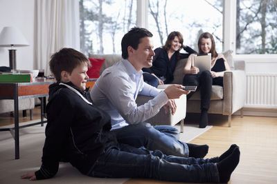 Family watching tv together in living room