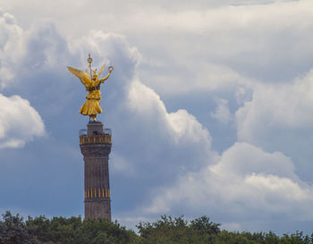 Low angle view of statue against cloudy sky