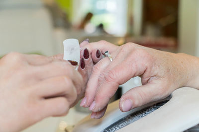 Close-up of hand giving manicure of customer