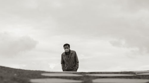 Rear view of man standing against sky