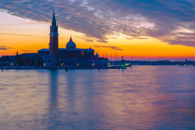 Scenic view of buildings against sky during sunset
