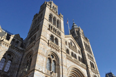 Low angle view of historic building against clear blue sky