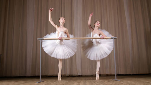 Ballet rehearsal, in old theater hall. young ballerinas in white ballet skirts, tutus