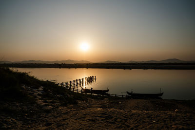 Scenic view of lake against sky during sunset