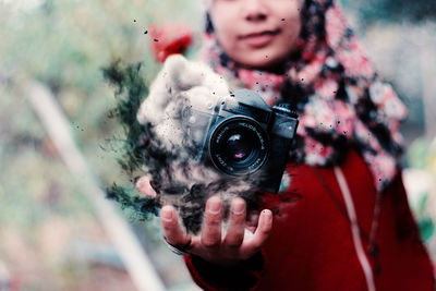 Portrait of woman photographing