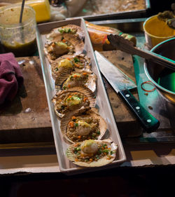 High angle view of cooked mussels as street food