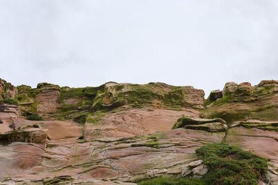 Rock formations on landscape against sky