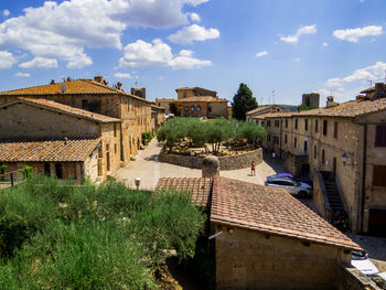 Buildings in town against sky