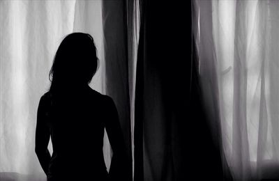 Woman looking through window