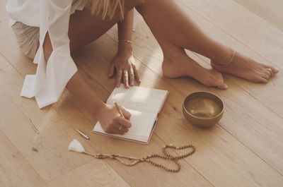 Low section of woman sitting on table