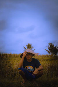 Portrait of senior man on field against sky