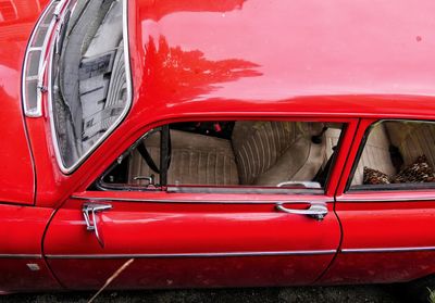 Close-up of red car on street