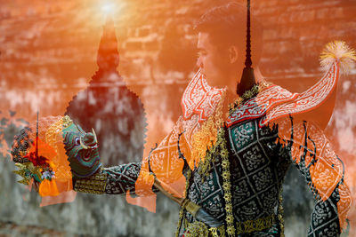 Rear view of woman holding umbrella