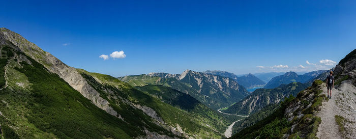 Panoramic view of mountains against blue sky