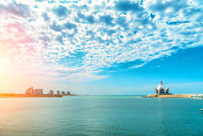 Scenic view of sea against sky in city