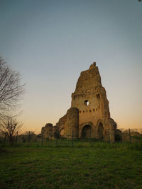 Old ruin on field against sky during sunset. rest of the ancient rome cistern. villa dei gordiano.