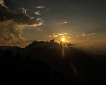 Silhouette of mountain against sky at sunset