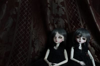 Portrait of a smiling woman sitting against wall