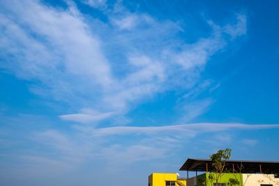 Low angle view of buildings against blue sky