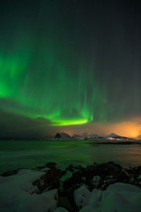 Scenic view of snowcapped mountains against sky at night