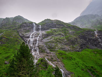 Scenic view of waterfall against sky