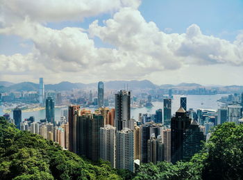 Modern buildings at victoria harbor against sky