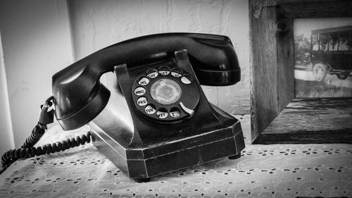 Close-up of telephone booth on table