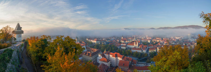 Cityscape of graz and the famous clock tower on shlossberg hill   styria region austria in autumn