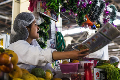 Rear view of woman in market stall during christmas