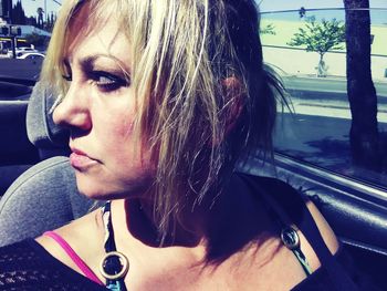 Close-up portrait of woman in car