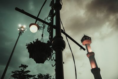 Low angle view of illuminated street light against sky