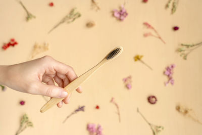 Close-up of woman holding hands over white background