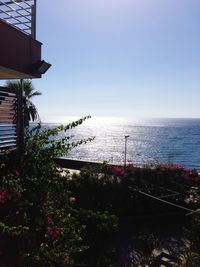 Scenic view of sea by buildings against sky