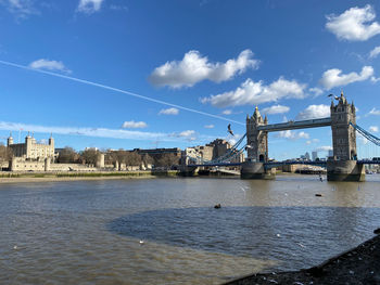 Bridge over river with city in background