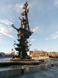 Low angle view of statue against cloudy sky