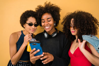 Portrait of happy young woman using smart phone