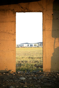 Abandoned building on field against clear sky