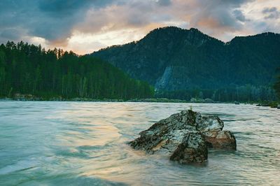 Scenic view of lake against sky during sunset