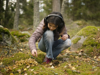 Young woman sitting on rock