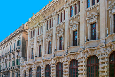 Low angle view of building against blue sky