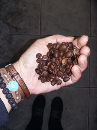 Low section of man holding coffee