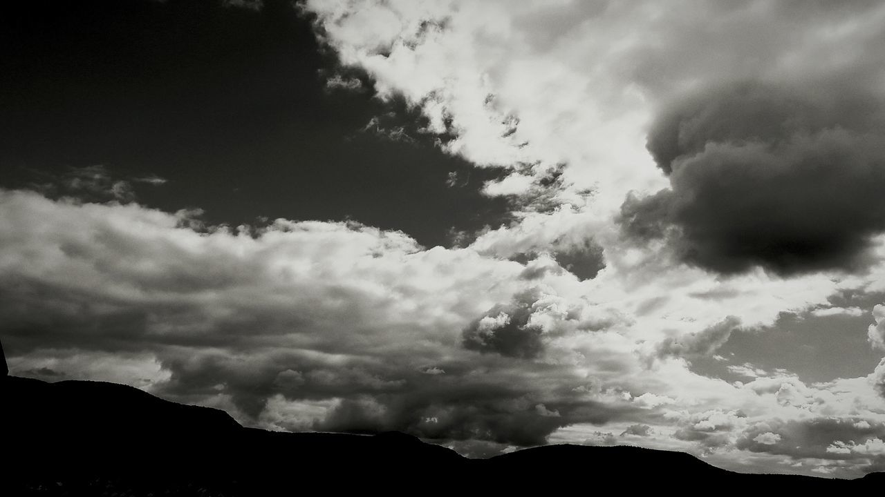 sky, scenics, tranquil scene, cloud - sky, tranquility, silhouette, beauty in nature, cloudy, mountain, nature, low angle view, cloud, cloudscape, weather, idyllic, landscape, overcast, mountain range, majestic, dusk