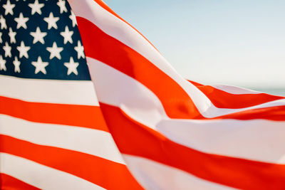 Close-up of flag against blue sky