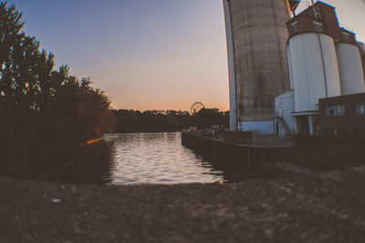 Bridge over river against sky during sunset