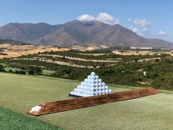 Scenic view of land and mountains against sky