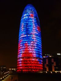 Low angle view of illuminated skyscrapers against sky at night