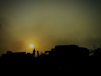 Low angle view of silhouette man against sky during sunset