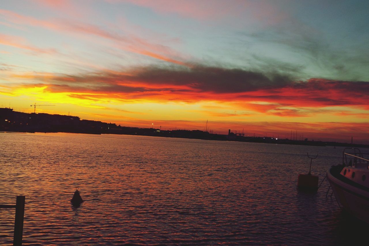 sunset, water, sky, orange color, waterfront, silhouette, cloud - sky, scenics, beauty in nature, sea, rippled, tranquility, tranquil scene, bird, nature, built structure, cloud, animal themes, architecture, transportation