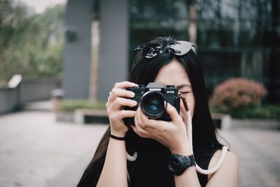 Portrait of woman photographing