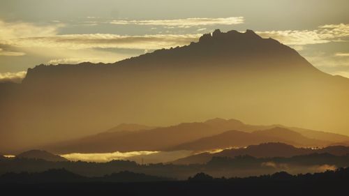 Scenic view of silhouette mountains against sky during sunset